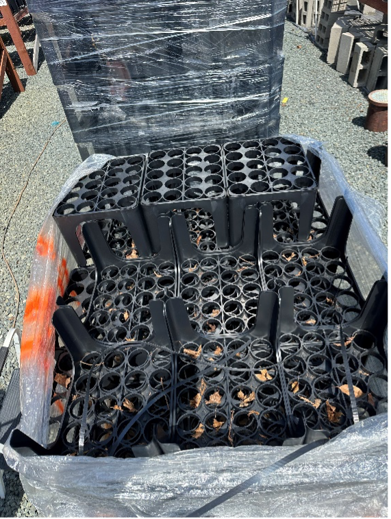 Clean stacked conetainer racks wrapped in plastic wrap.