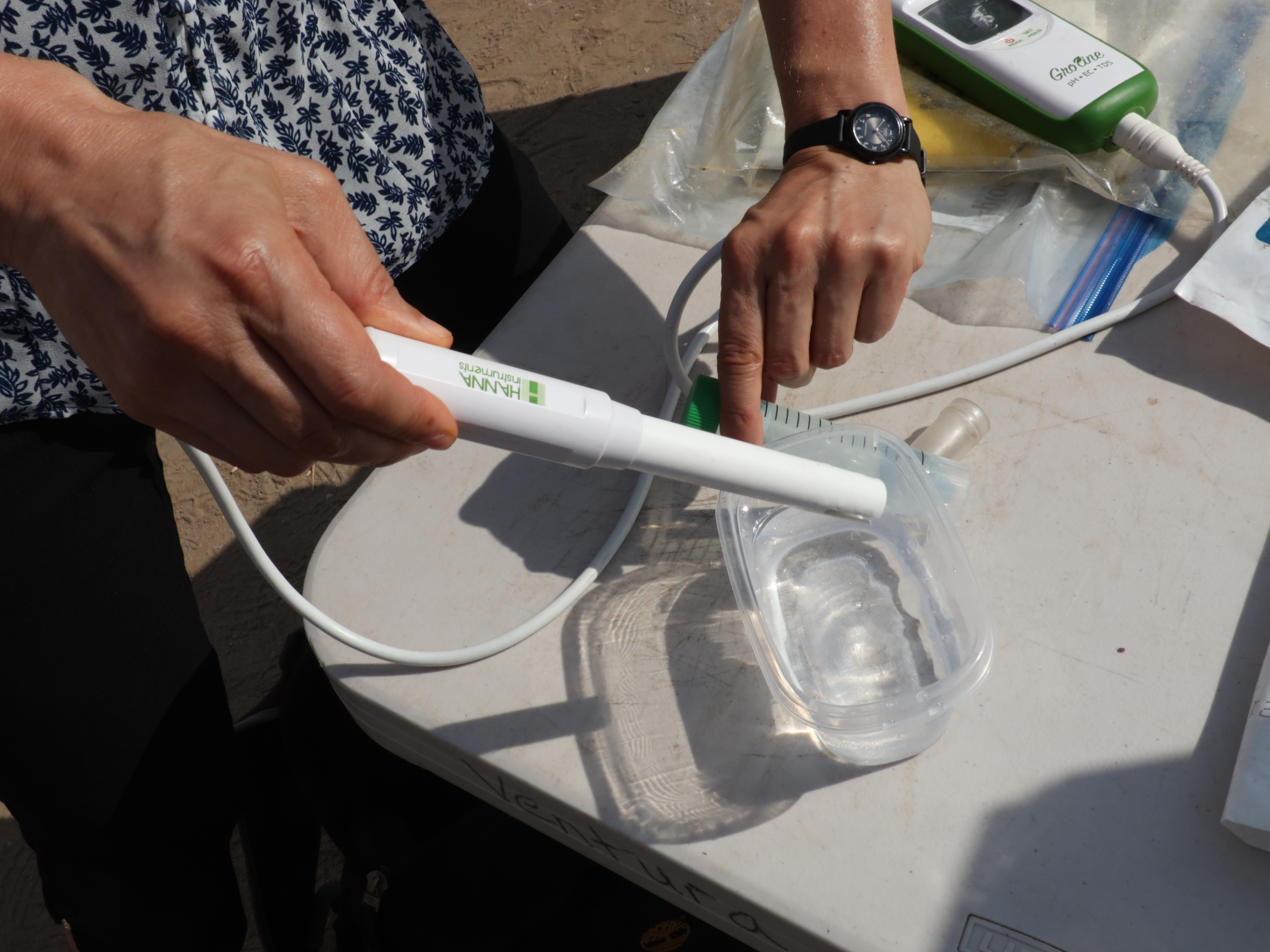 An electrical conductivity meter testing a small volume of water.