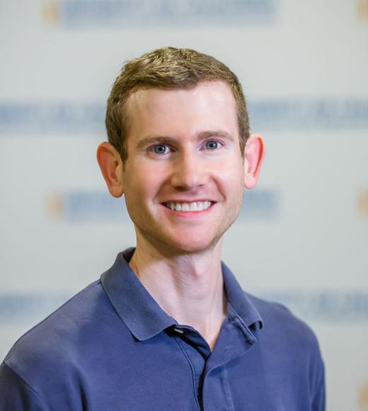 Profile Photo of Grant Johnson. A man with short blonde hair wearing a blue polo.